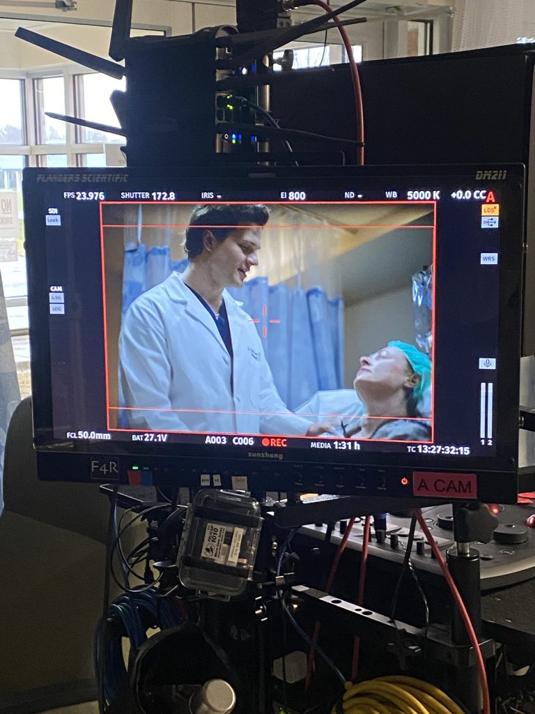 Behind the scenes look at doctor conversing with patient.