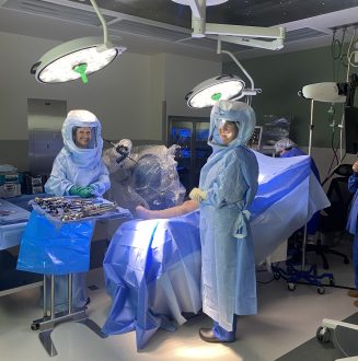 Two surgical team members smiling before procedure starts